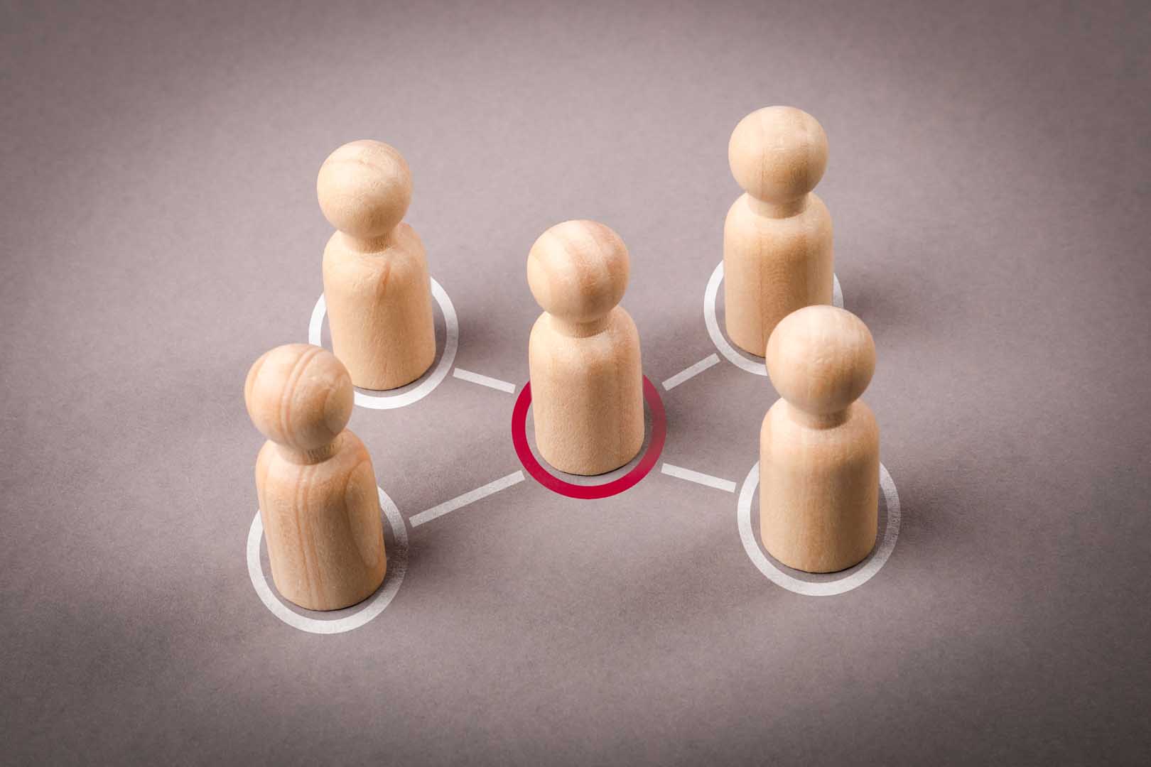 Wooden,Figures,On,A,Gray,Background.,Intermediary,Between,Groups,Political