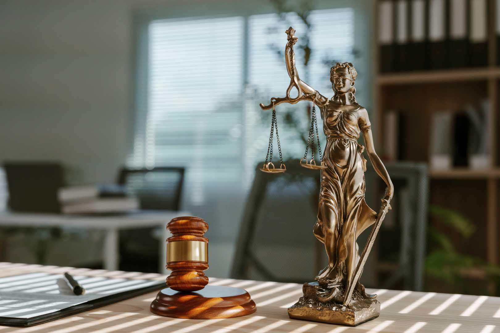 Sunlight,Shining,Through,Window,Blinds,Onto,Themis,Statue,,Gavel,And